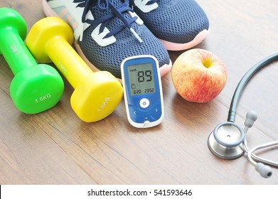 Sport Shoe With Glucose Meter,stethoscope,fruits And Dumbbells For Using In Fitness, Concept Of Diabetes, Exercise In Diabetes Patients Concept.