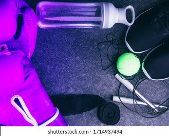 sport sneakers, leather boxing gloves, jump rope, tennis ball, bottle of water, women boxing concept, copy space, toned on trendy neon colors - Powered by Shutterstock