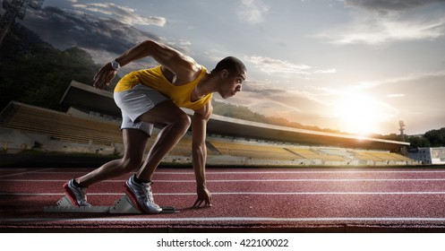 Sport. Sprinter leaving starting blocks on the running track.  - Shutterstock ID 422100022