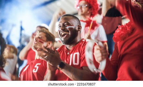 Sport Stadium Soccer Match: Diverse Crowd of Fans Cheer for their Red Team to Win. People Celebrate Scoring a Goal, Championship Victory. Group People with Painted Faces Cheer, Shout, Have Fun - Shutterstock ID 2231670837