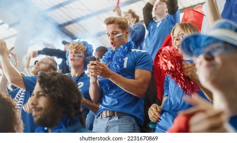 Sport Stadium Soccer Match: Portrait of Excited Caucasian Couple Cheering Team to Win, Use Smartphone to Check App, Bet, Score, Winnings. Crowd Celebrate Goal, Championship Victory - Shutterstock ID 2231670869