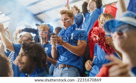 Sport Stadium Soccer Match: Portrait of Excited Caucasian Couple Cheering Team to Win, Use Smartphone to Check App, Bet, Score, Winnings. Crowd Celebrate Goal, Championship Victory