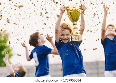 Sport Team Celebrating Success. Happy Boys Rising Golden Trophy On Celebration. Children Winning Sports Soccer Tournament Competition. Inter-school Sport Competition