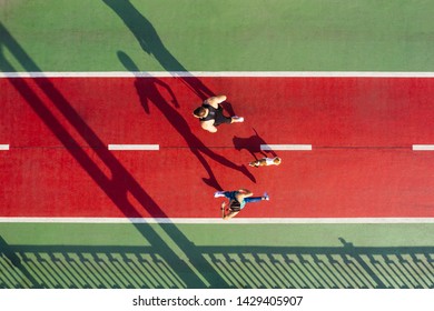 Sport Theme. Runners With Dog On Green And Red. Summer Morning Active Couple. Aerial Drone Top View