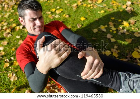 Sport training tibia fracture injury. Male athlete grabbing painful leg.