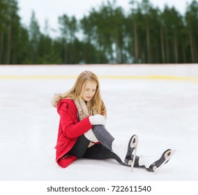 Sport, Trauma And Winter Concept - Young Woman With Knee Injury Suffering From Pain On Skating Rink