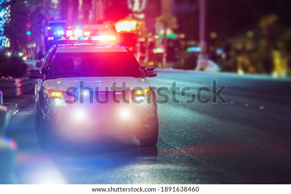 Sport Utility\
Vehicle Police Cruiser Emergency Assistance on the City Street.\
Police Car with Flashing\
Lights.