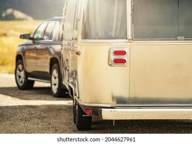 Sport Utility Vehicle With Retro Classic Travel Trailer Road Trip. RV Adventures Theme.