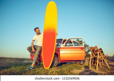 Sport, Vacation, Travel, Summer Concept. Caucasian Man Standung Near Car With Surfboard At Nature