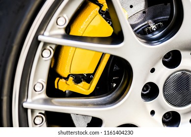 Sport  Wheel Rim Close Up. Detail Of Yellow New Brake Pads Changed On Luxury Car.