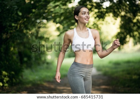 Similar – Fit healthy athletic woman jogging on a river bank