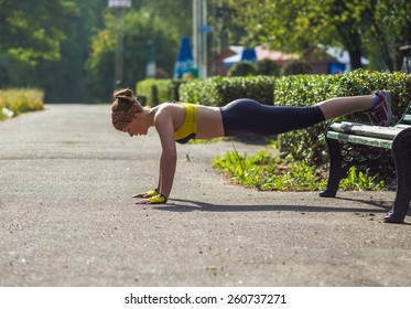 Sport woman doing push-ups during outdoor cross training workout