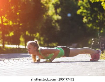 Sport woman doing push-ups during outdoor cross training workout