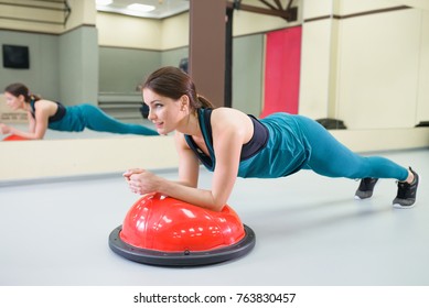 Sport Woman Exercise With A Balance Ball At Gym, Plank Position.