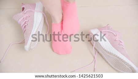 sport woman has athletes foot and itching her foot wearing socks