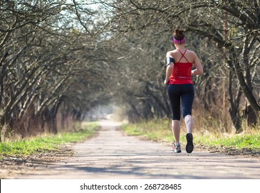 Sport woman jogging outside in morning