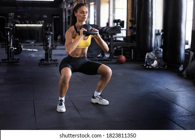 Sport woman with kettlebell in the gym. - Powered by Shutterstock