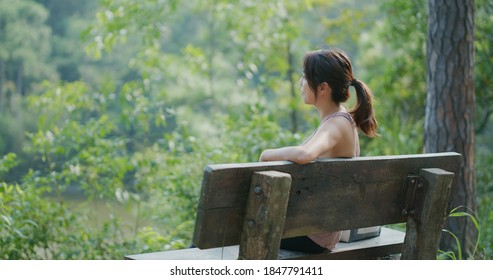 Sport Woman Look At The Lake View And Sit On The Bench