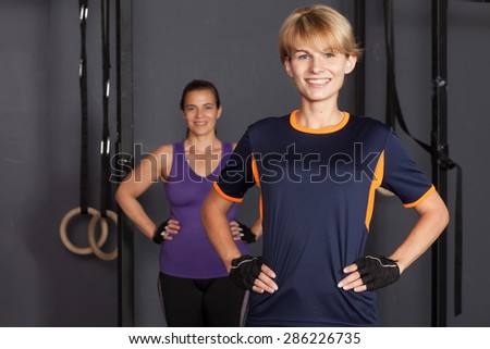 Similar – Close up front portrait of three young and middle age athletic women in sportswear in gym over dark background, looking at camera