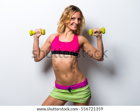 Similar – One young athletic woman at crossfit training, exercising with trx suspension fitness straps over dark background, front view, looking at camera