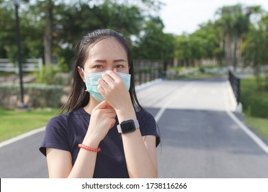 Sport Woman In Medical Protective Mask Relaxing In The Park.  Campaign To Use Protective Mask From COVID19