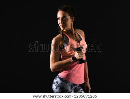 Similar – Side profile view portrait of one young athletic woman at crossfit training, exercising with trx suspension fitness straps over dark background, looking away