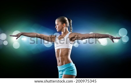 Similar – Close up side view profile portrait of one young athletic woman shadow boxing in sportswear in gym over dark background, looking away