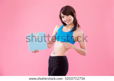 sport woman take weight scale on the pink background