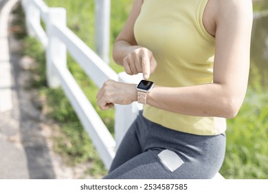 Sport woman touch on smart watch after running  - Powered by Shutterstock