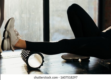 Sport Woman Using Foam Black Roller for Muscle and Fascia Stretching Foot 
