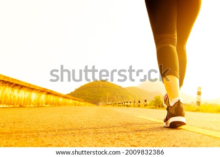 sport woman walking towards on the road side. Step concept