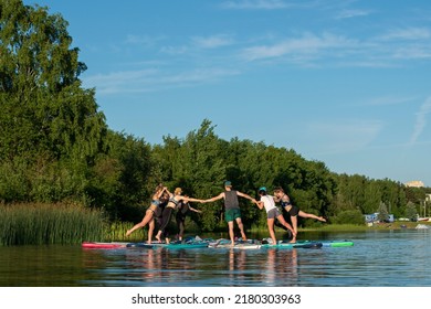 Sport woman yogini scorpion pose practice yoga exercise on sup board on the sea in relaxing day , yoga is meditation and healthy sport concept.yoga on a paddle board