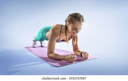 Sport. Young Athletic Woman Doing Plank. Muscular And Strong Girl Exercising. Fitness Exercising.