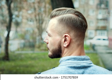 sport young man with a modern trendy fade profile haircut for barbershop.