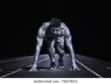 Sport. Young Runner On The Start Line. Isolated On Black. Stylized Photo