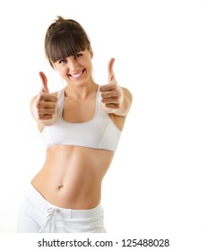 sport young woman with perfect body show victory gesture, fitness girl studio shot over white background
