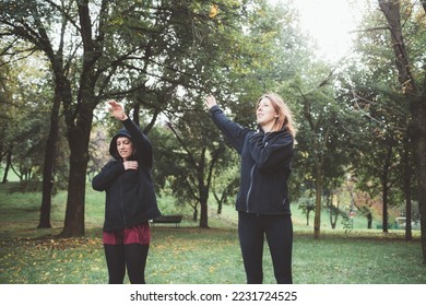 Sportive athletic women training outdoors stretching before intense workout - Powered by Shutterstock