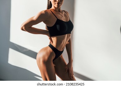Sportive body type. Young caucasian woman is indoors at daytime. - Shutterstock ID 2108235425