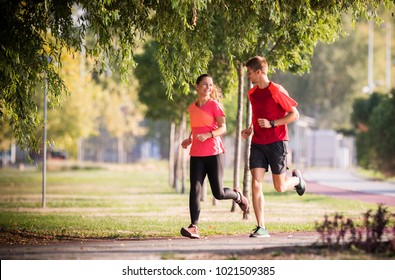  Sportive Couple Running In Park