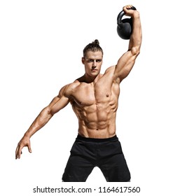 Sportive guy training with kettlebell. Photo of handsome man with naked torso and good physique on white background. Strength and motivation.