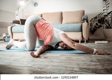 Sportive And Healthy. African American Overweight Woman Standing On Her Knees In Weird Meditative Pose