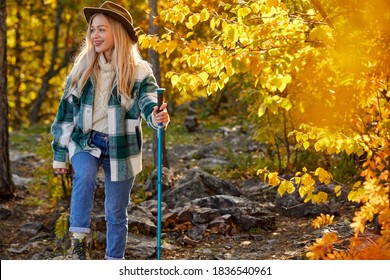 Sportive Hiking Woman Is Climbing Mountains Using Hiking Cane, Blonde Female Is Enjoying Outdoor Recreation, In The Forest, Exploring Nature