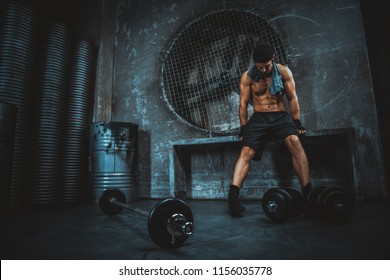 Sportive man training in a gym and taking a rest- Functional training workout - Powered by Shutterstock