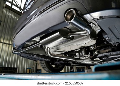Sportive mufflers. Oval or round Car Exhaust Tailpipe chromed made of stainless steel on powerful sport car bumper. Exhaust silencer, metal fittings and pipes for the muffler - Shutterstock ID 2160550589