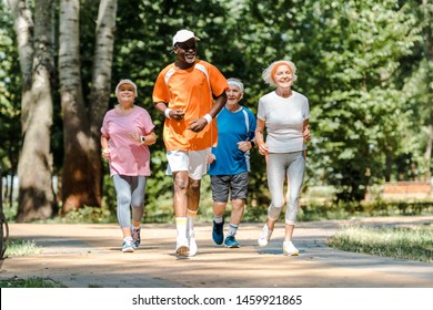 sportive multicultural and senior men and women running in park  - Powered by Shutterstock