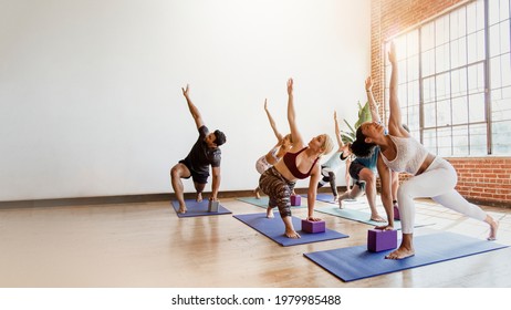 Sportive People Doing Parivrtta Trikonasana