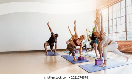 Sportive People Doing Parivrtta Trikonasana