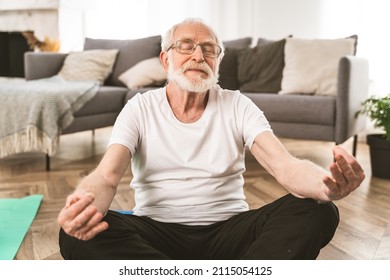 Sportive senior man doing fitness and relaxation exercises at home - Elderly people training to stay healthy and fit - Powered by Shutterstock