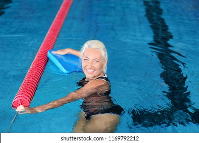 Sportive Senior Woman In Indoor Swimming Pool