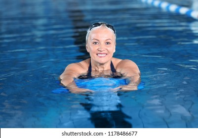 Sportive Senior Woman In Indoor Swimming Pool